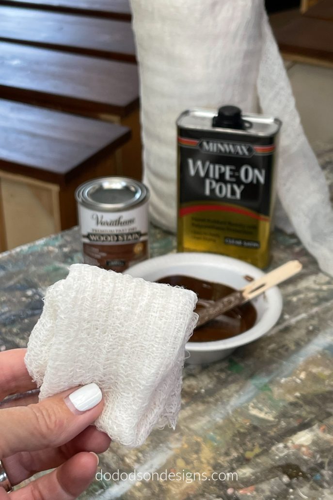 To re-stain the wood drawers on this black painted dresser I used a low lint cheese cloth to apply the stain. It worked beautifully.