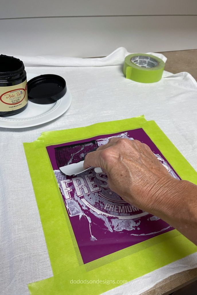 Choose your favorite Dixie Belle chalk mineral paint color and add a small amount of paint on the thing-a-ma-jig or the squeegee hand applicator that comes in the silkscreen package and gently drag across the stencil. Remove any excess from the stencil before removing the stencil from the fabric. Instant DIY flour sack towels. So CUTE!