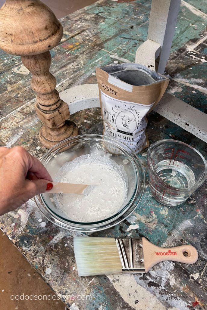 Mix the milk paint powder with water in a bowl and stir, stir, stir! It will be a little lumpy but that's okay. Get all the details of this chippy paint finish for wood furniture over on my blog.