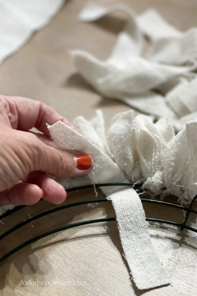 Tie each strip of fabric to the wire frame to make an amazing DIY wreath. It so simple and takes less than an hour to complete.