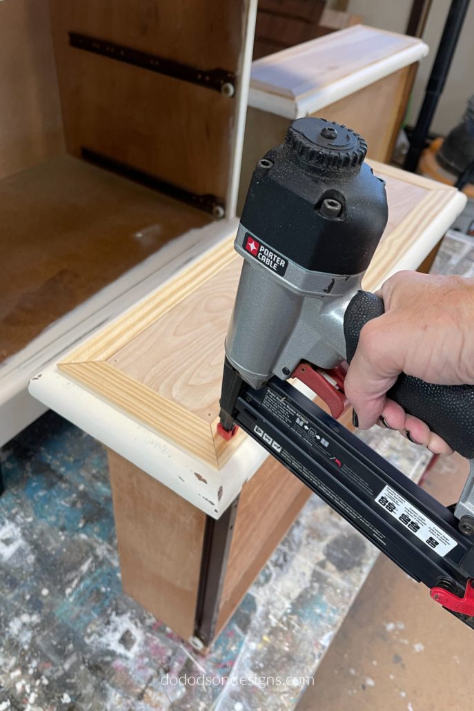 Basically, you're creating a frame to cover the ugly drawer front area. Apply the adhesive to the trim as well for extra stickability and secure with pin nails. Your drawer front makeover will look amazing!