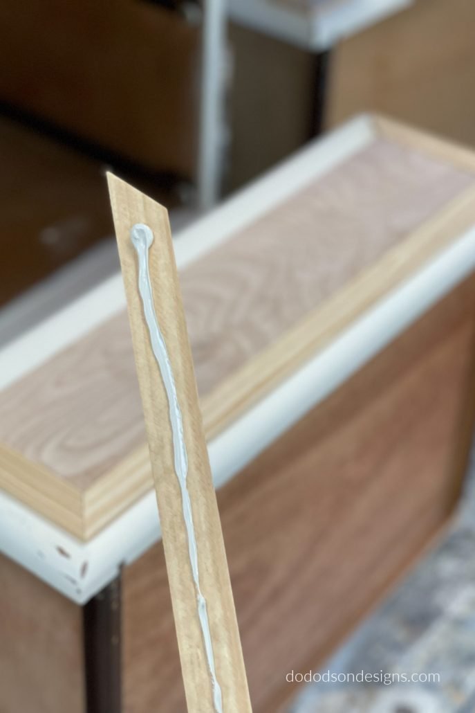 To give the drawer front makeover it a finished appearance, use a wood trim around the plywood using a 45 degree cut to cover up the raw edges. I used pine wood because it's softwood and is easy to sand the edges with 220 grit sandpaper for a finished smooth edge.