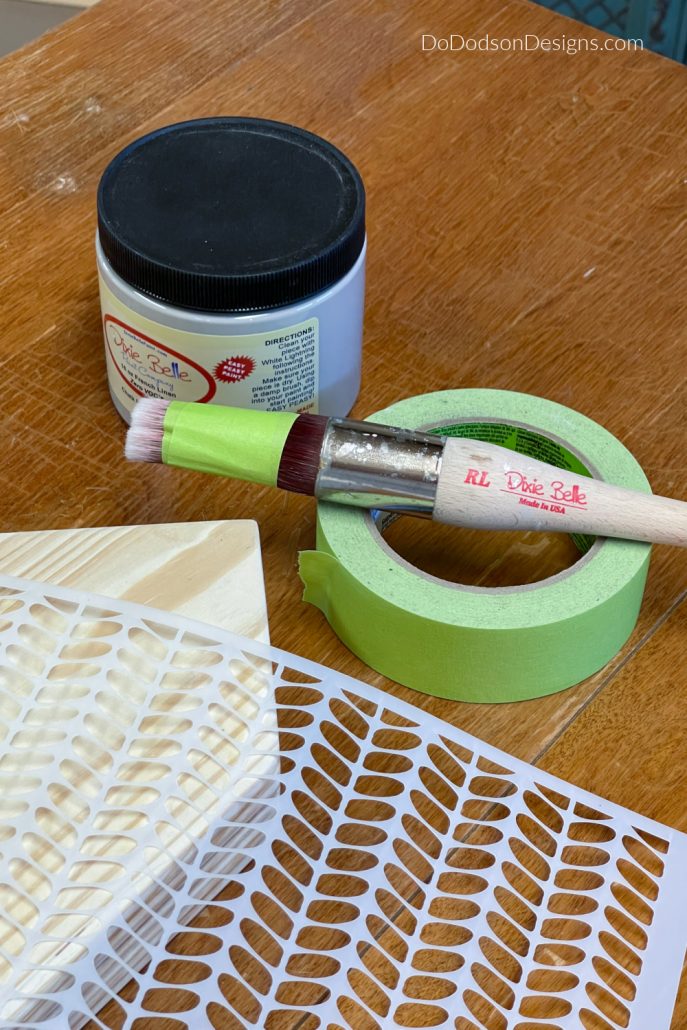 Use a stencil brush to apply the design you want on your wood block houses. If you don't have a stencil brush, improvise and use painter's tape around a synthetic paintbrush. It works great!