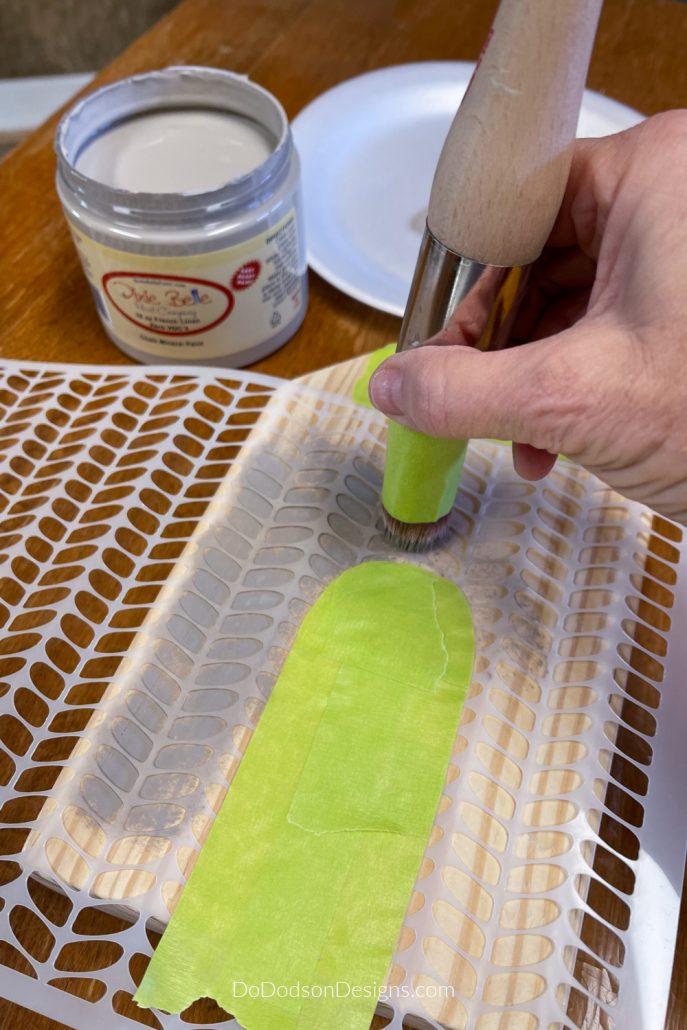 Carefully stencil on your design. Use a minimal amount of paint to prevent bleeding under the stencil. Less is more. You can always go back and reapply more if needed. I like to use a paper plate or paper towel to blot the excess paint from the stencil brush before applying. Only the tips of the bristles should have paint. Tap the ends of the paintbrush or stencil brush lightly over the stencil using an up and down motion. DO NOT paint over the stencil with a back and forth motion. This will cause bleeding due to the paint that will build up around the sides of the stencil.
