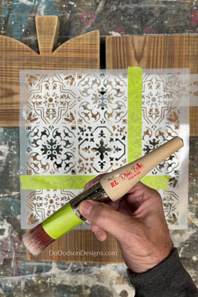 Lay the stencil over your wood table riser. I used painter's tape to outline the section of the pattern I wanted to use. Doing this allows me to use these larger stencils on small projects.