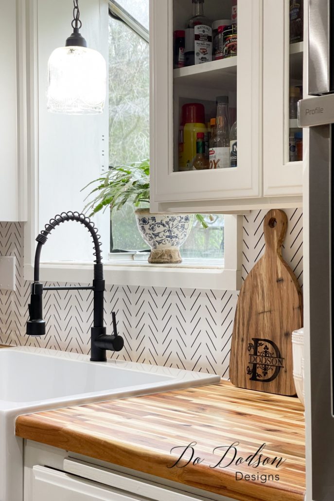 The easiest DIY peel and stick wallpaper backsplash you'll ever do in your kitchen. It's the perfect temporary alternative when you can't decide on a design.