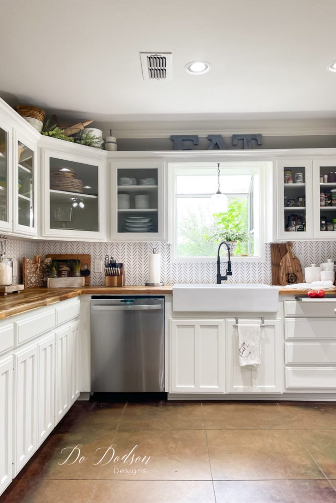 The easiest DIY peel and stick wallpaper backsplash you'll ever do in your kitchen. It's the perfect temporary alternative when you can't decide on a design.