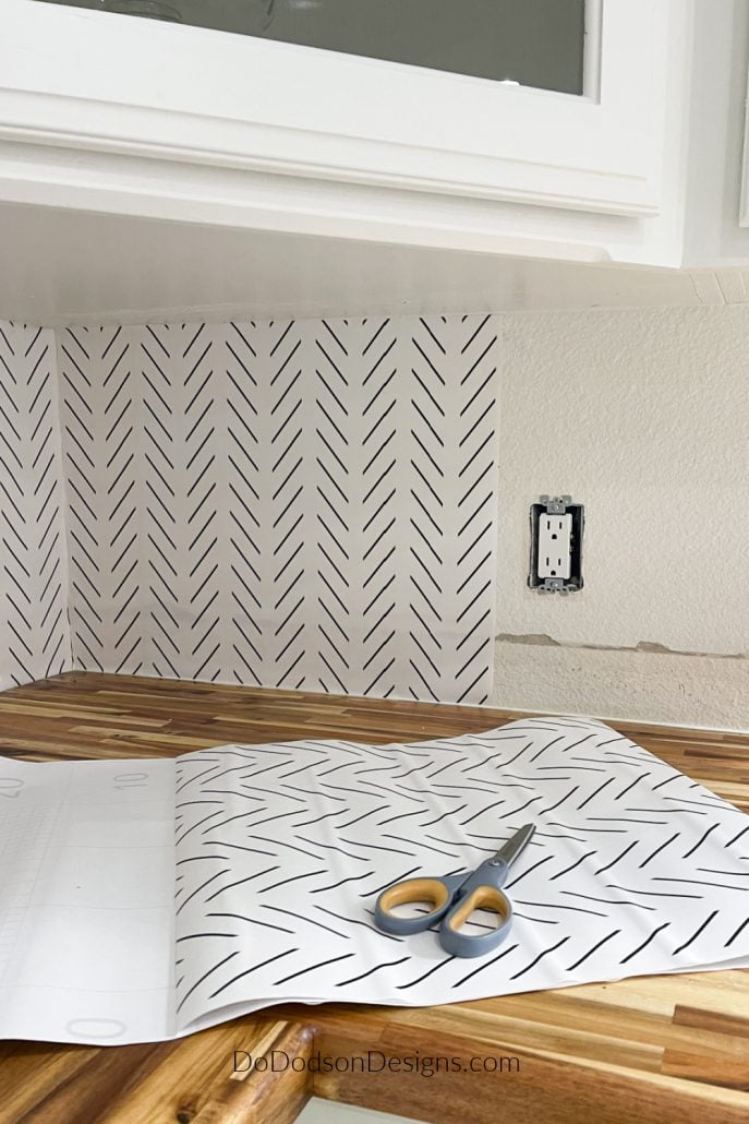 Try this easy DIY peel and stick wallpaper backsplash idea when you can't decide in your kitchen. It's a great alternative and so affordable.