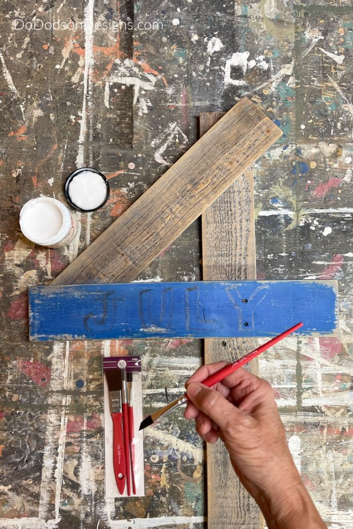Now you can paint your letters using a chisel artist brush with confidence on your 4th of July Decor Sign.