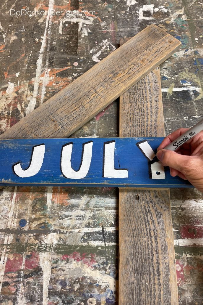 Using a sharpie pen for shading letters on signs.