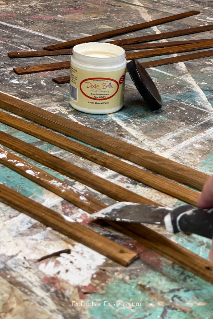 To get a chippy paint look over stain, you simply drag the paint along the wood with a putty knife.