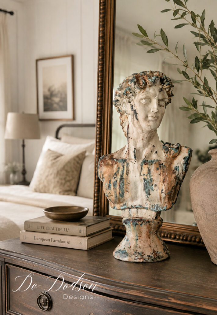 Thrift store Bust of David with an aged patina finish styled on a vintage wood dresser in a warm farmhouse bedroom.