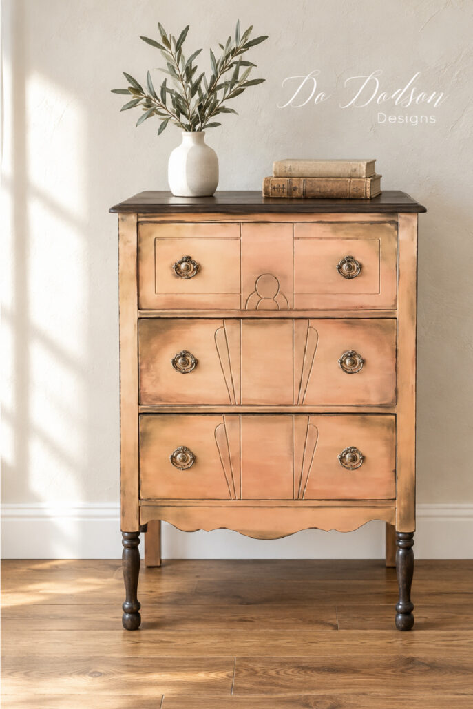 Finished thrift furniture makeover with a dark stained wood top, layered copper paint, and vintage hardware.