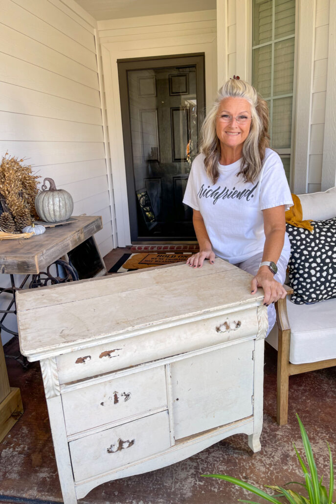 Do Dodson with a worn antique washstand before restoring the curbside furniture find with a fresh painted finish.