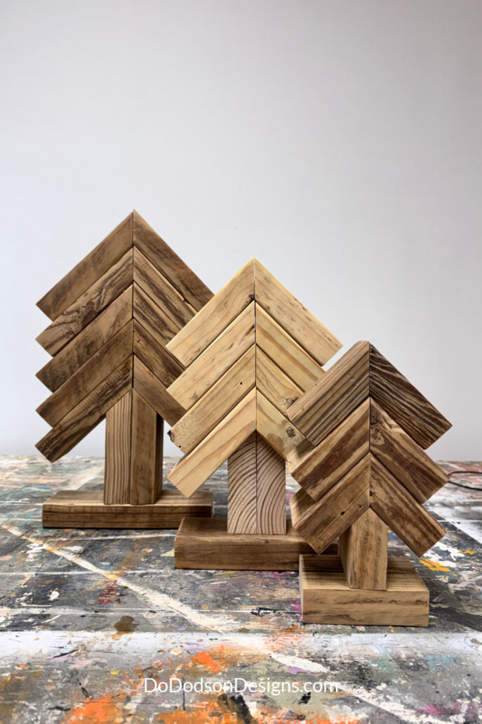Three assembled 2x4 scrap wood Christmas trees in small, medium, and large sizes