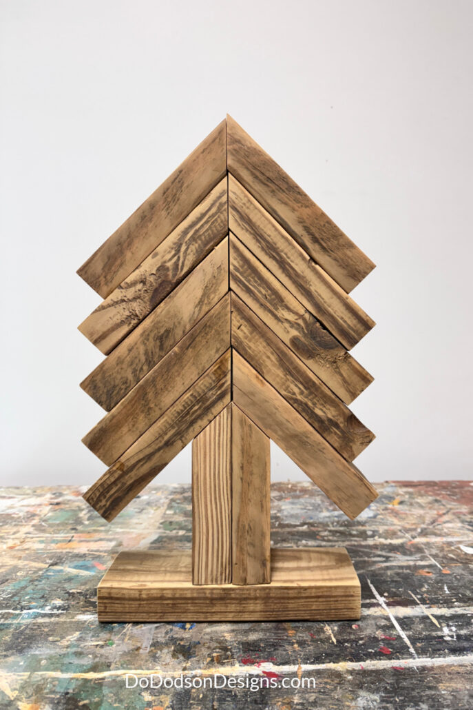 Large 2x4 scrap wood Christmas tree with five tiers, a two-piece trunk, and a rectangular wood base
