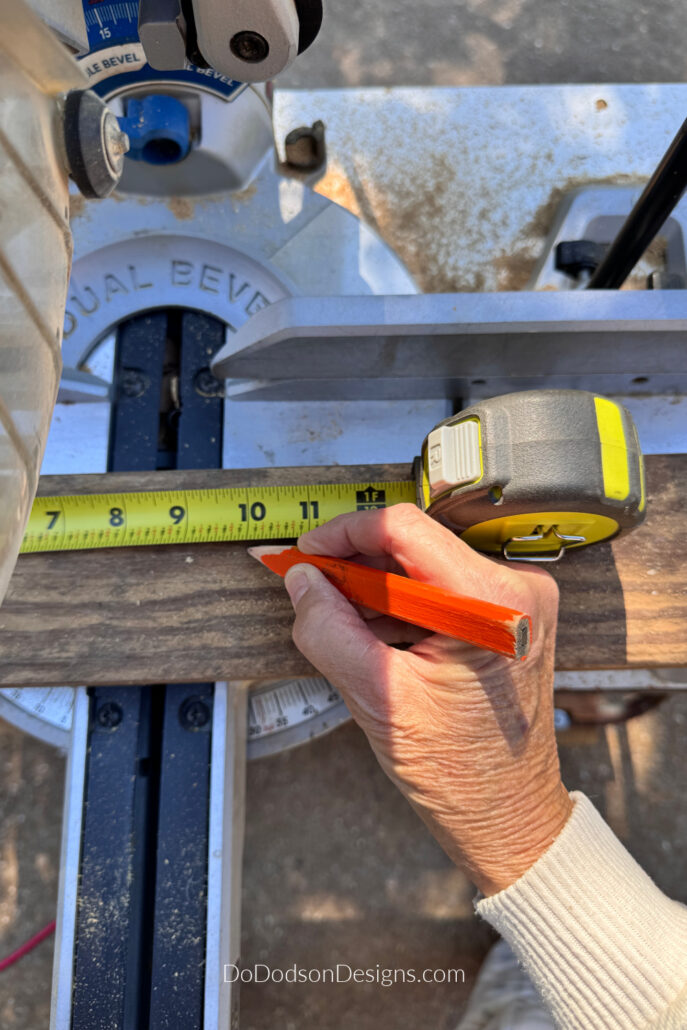 Measuring and marking a scrap 2x4 for a DIY wood Christmas tree.